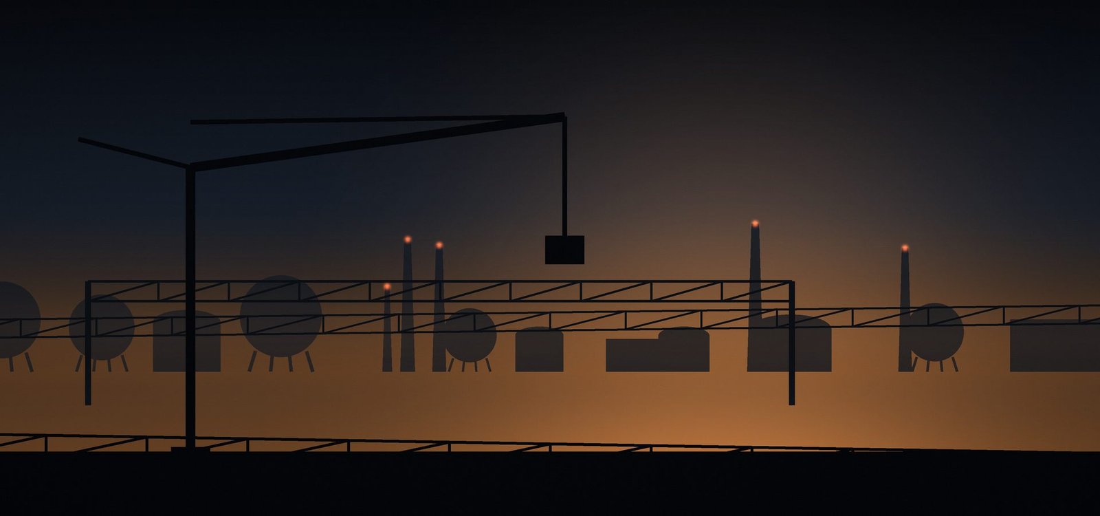 Fabrication yard and gantry silhouetted at dusk